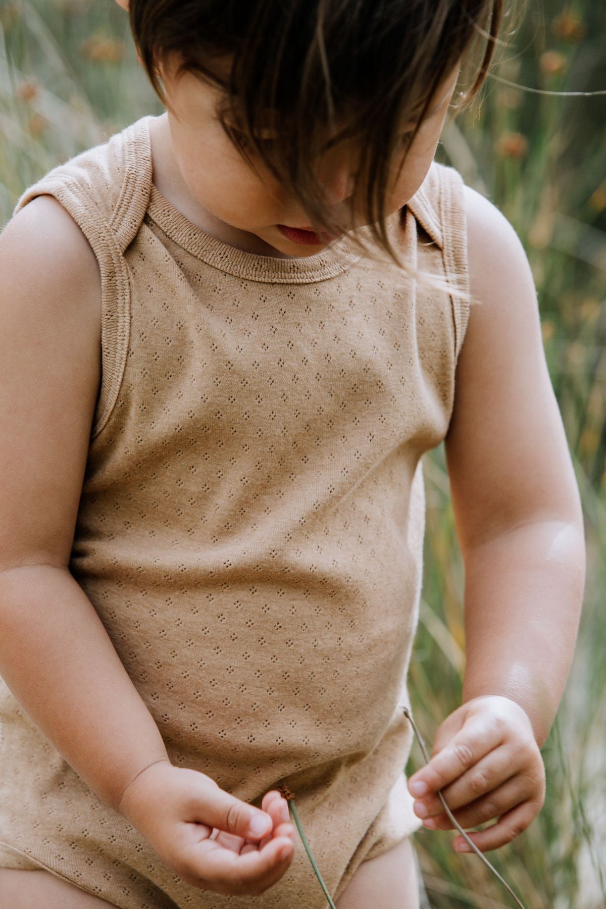 Zoom in Baby in sleeveless bodysuit