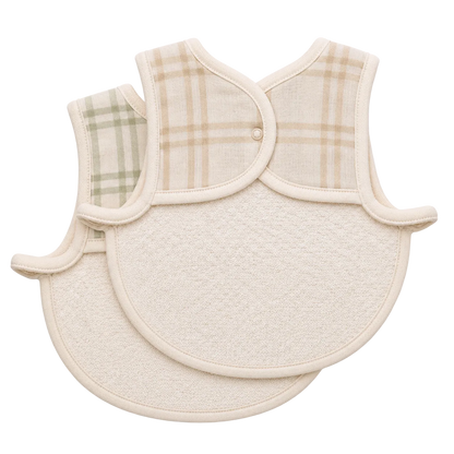 Two baby bibs with plaid and textured designs on a white background