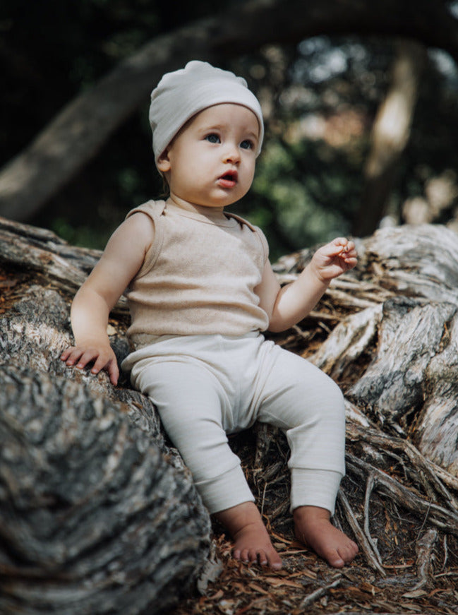 Baby in Beanie, Sleeveless bodysuit and long Pants 